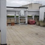 Enclosure at the top of a building projecting onto a department store wall below